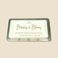 Load image into Gallery viewer, Wax melt with 'Berries & Blooms' fragrance on a stone surface with decorative elements.