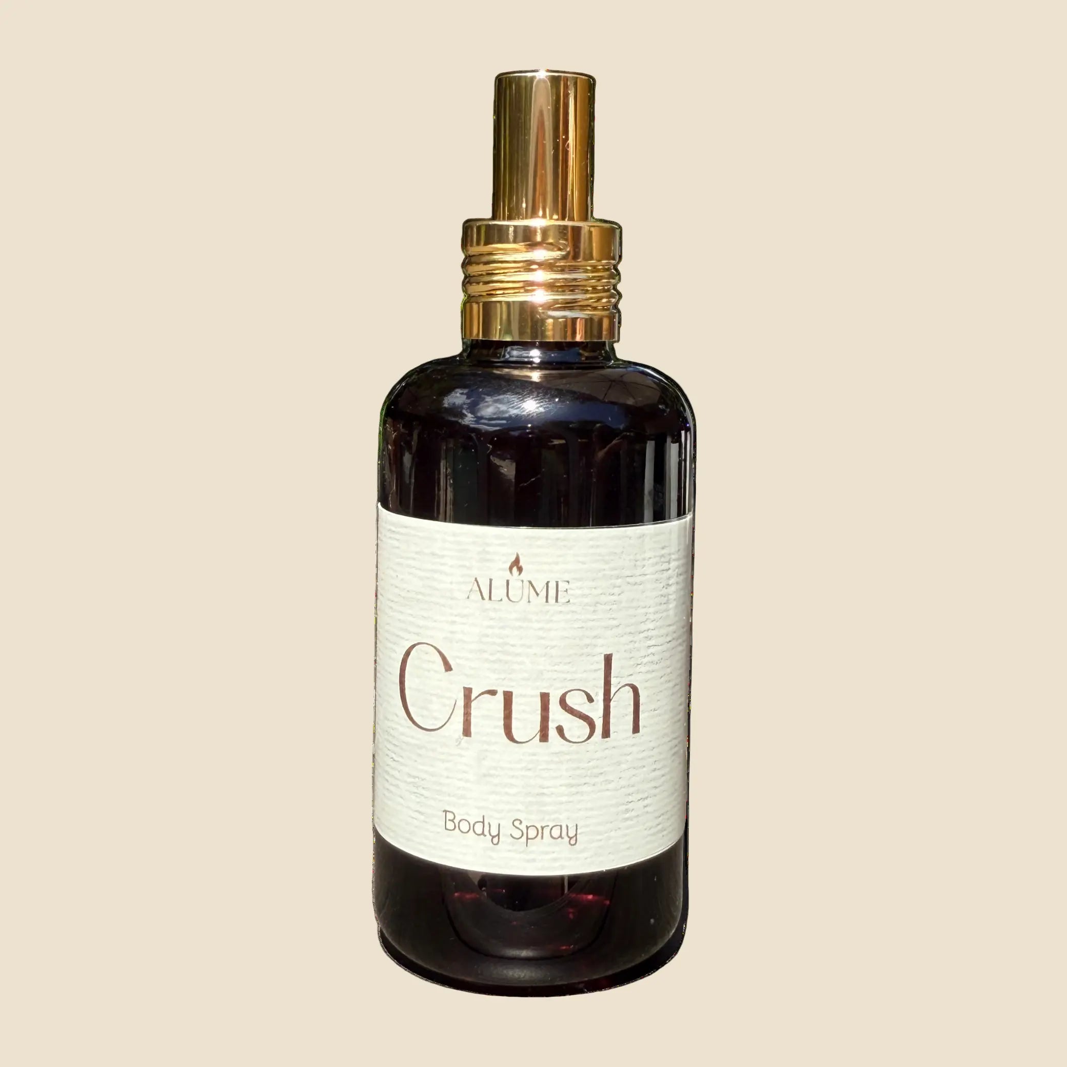 Body spray bottle labeled 'Crush' with a gold nozzle on a white background
