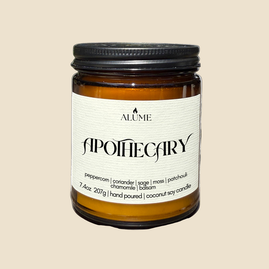Candle jar with 'Alume Apothecary' label on a white background