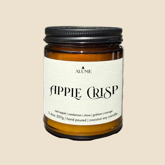 Candle jar labeled 'Apple Crisp' by Alume on a white background