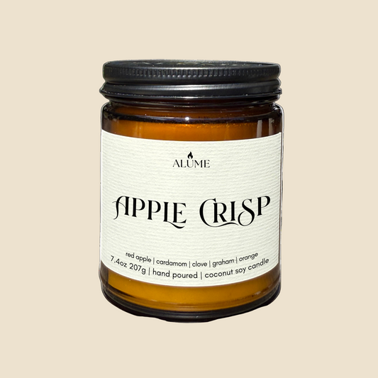 Candle jar labeled 'Apple Crisp' by Alume on a white background