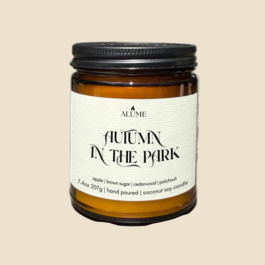 Candle jar labeled 'Autumn in the Park' by Alume on a white background