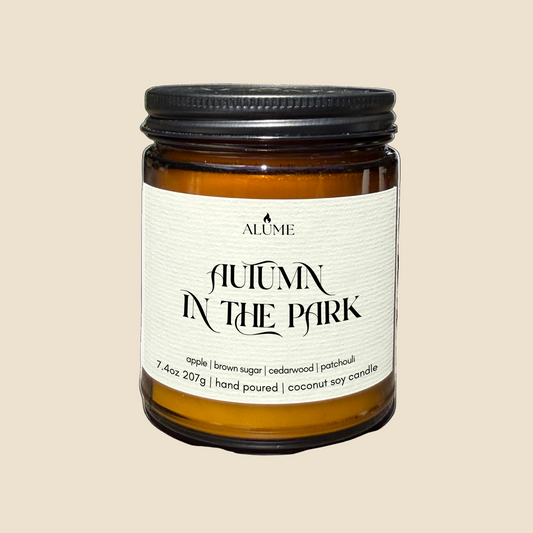 Candle jar labeled 'Autumn in the Park' by Alume on a white background