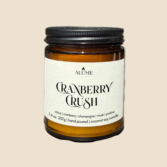 Candle jar labeled 'Cranberry Crush' by Alume on a white background
